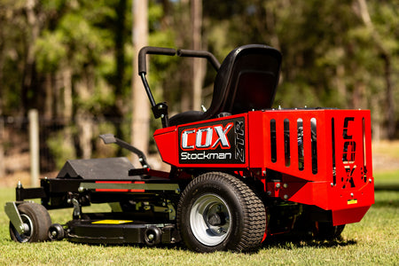 Product photo of a COX Mowers Compact ZTR 35 zero turn ride on lawn mower with trees in the background