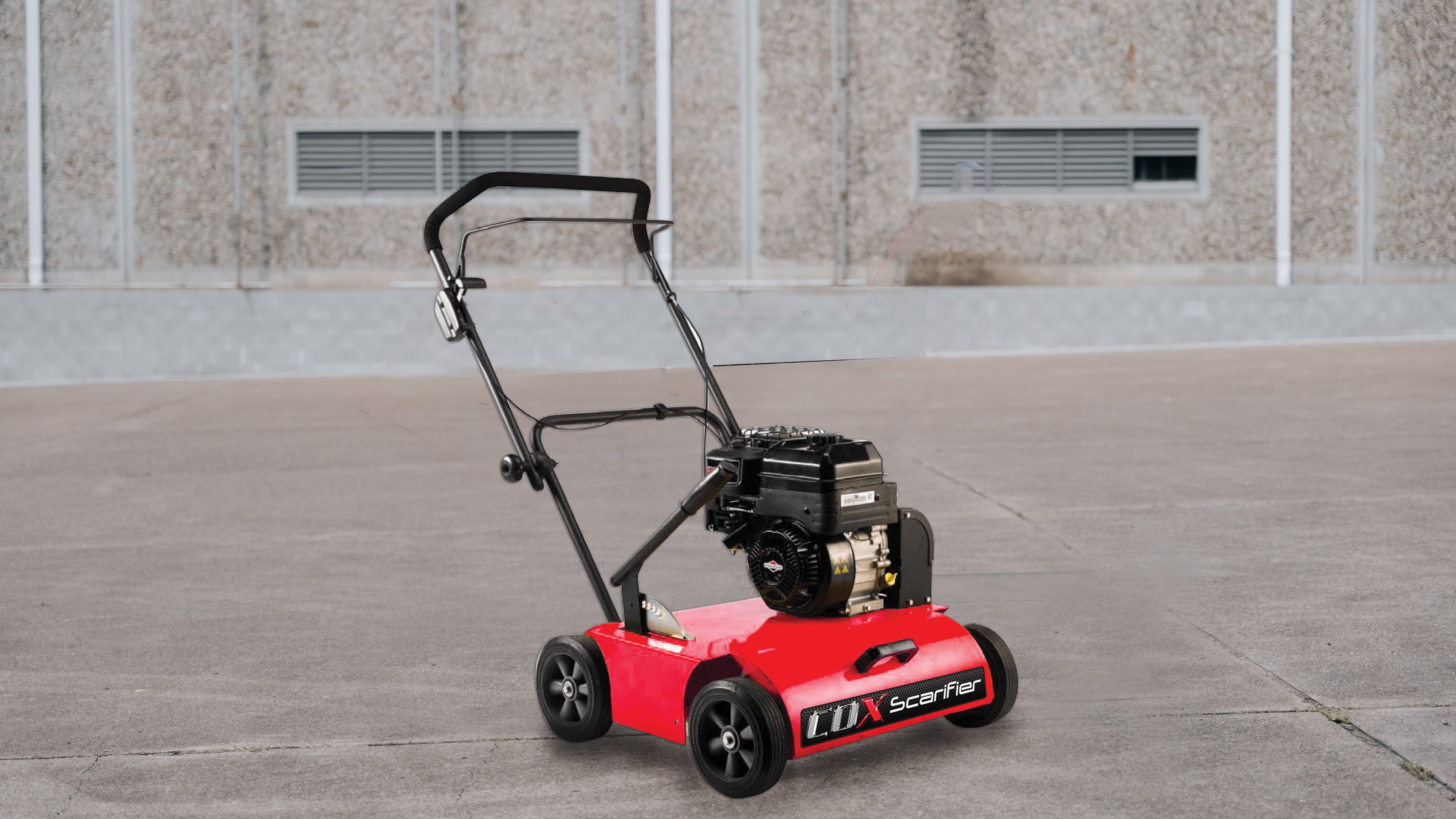 Photo of COX Mowers Scarifier on a concreted area with building in the background
