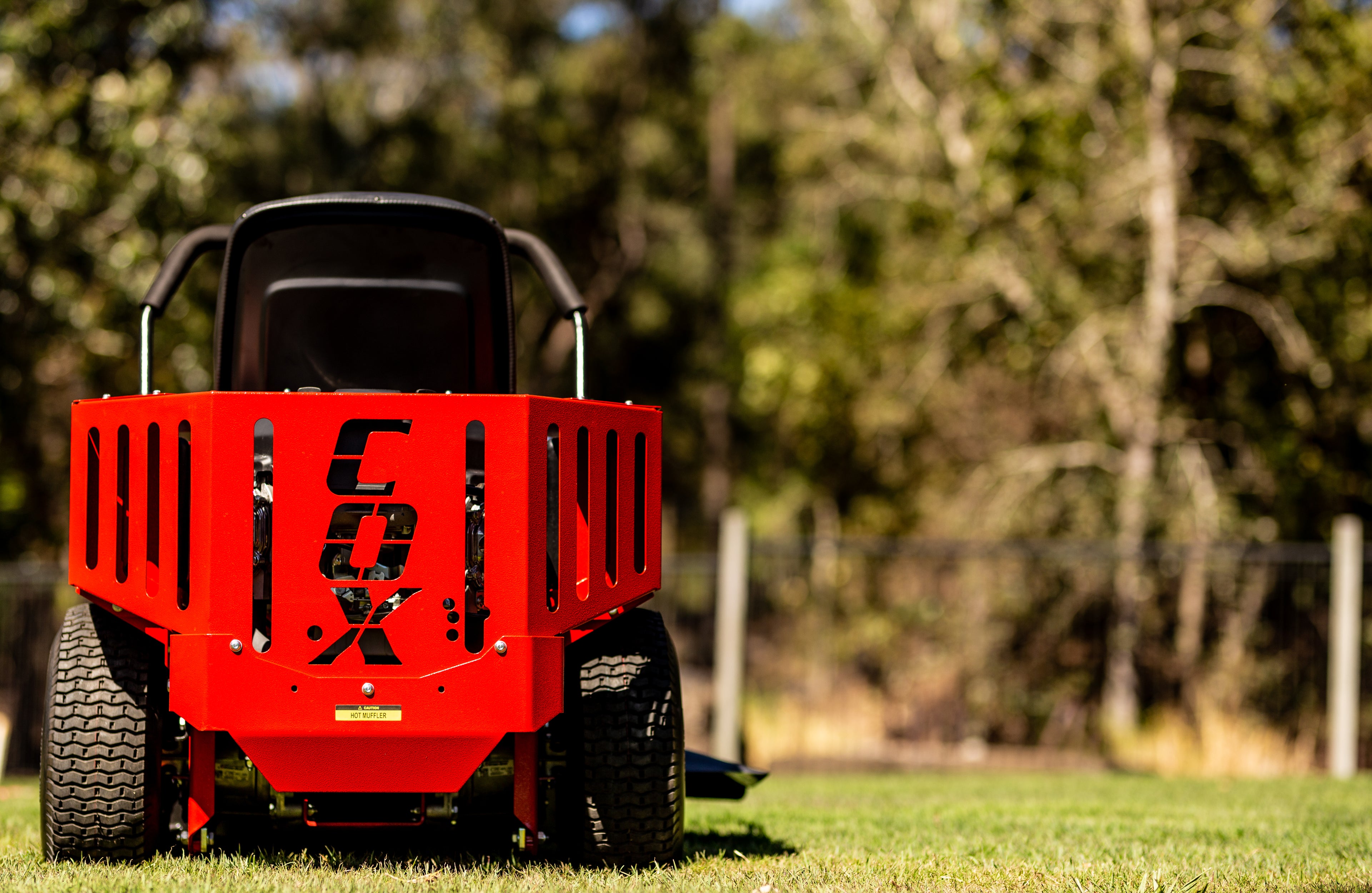 Load video: Rear Photo of COX Mowers Compact ZTR 35 with trees in the background